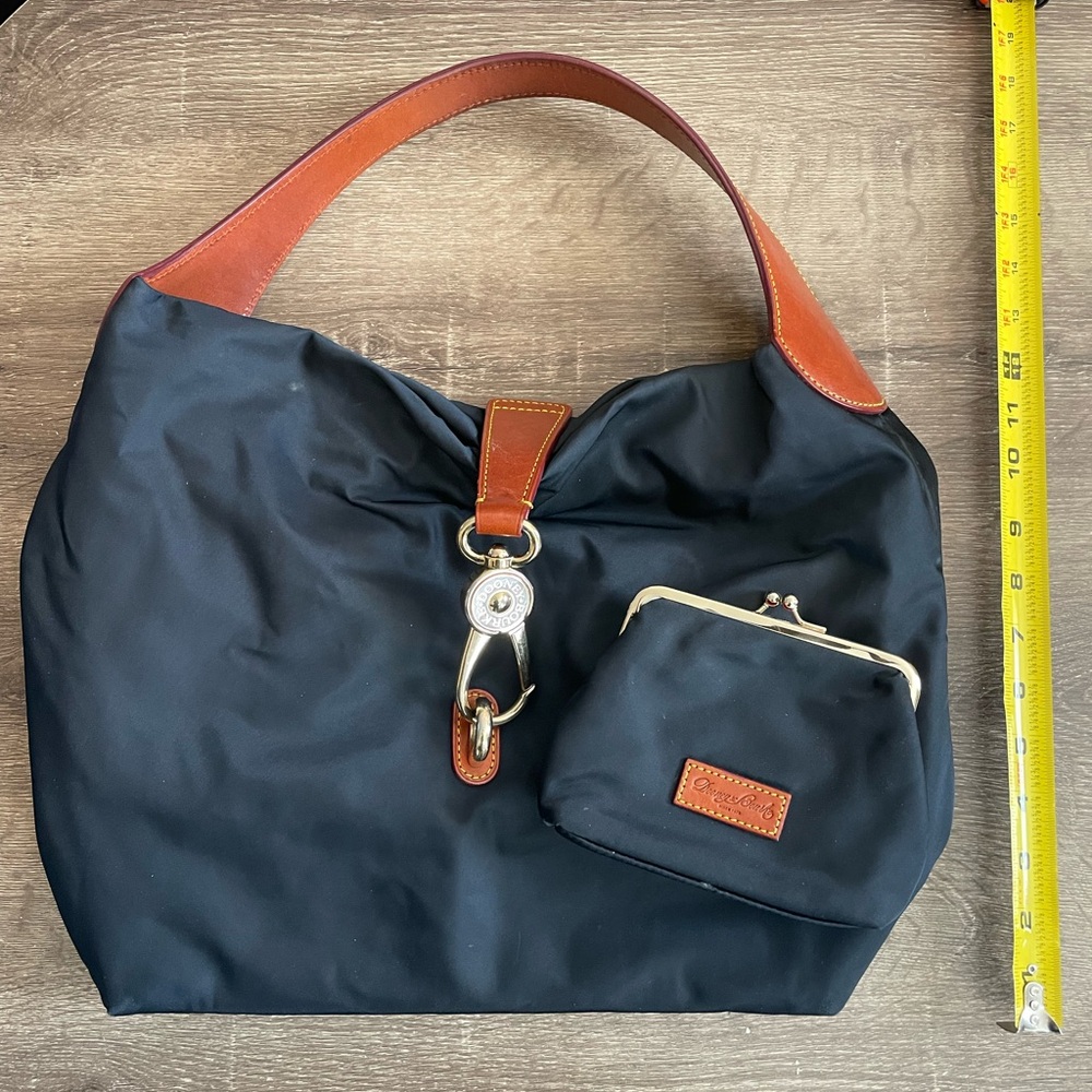 Dooney and Bourke navy nylon and leather bag with matching kiss-lock wallet.
